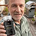 A man holding a bottle of HoneyFil